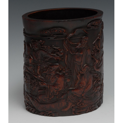 737 - A Chinese bamboo bitong brush pot, carved in relief with Guanyin and immortals, 16.5cm high