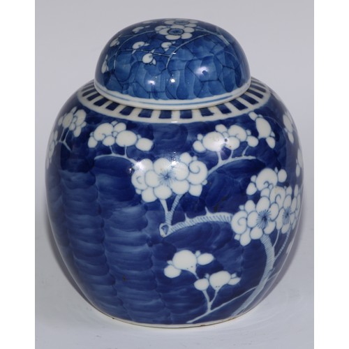 749 - A Chinese ovoid ginger jar and cover, painted in tones of underglaze blue with blossoming prunus on ... 