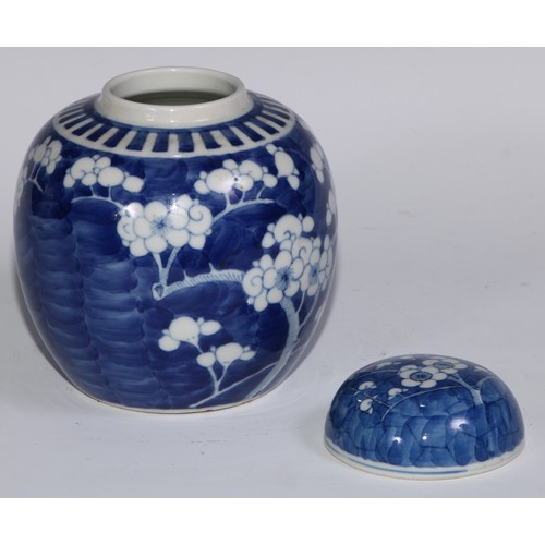 749 - A Chinese ovoid ginger jar and cover, painted in tones of underglaze blue with blossoming prunus on ... 