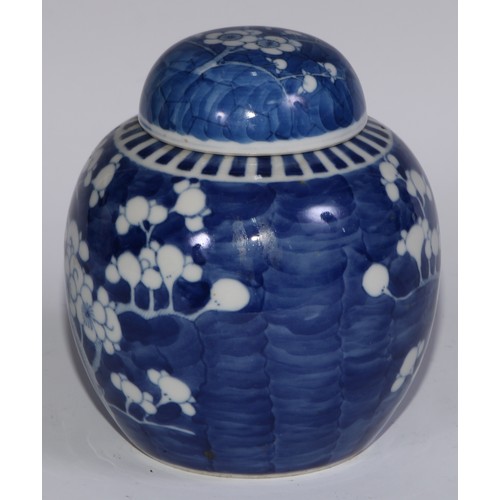 749 - A Chinese ovoid ginger jar and cover, painted in tones of underglaze blue with blossoming prunus on ... 