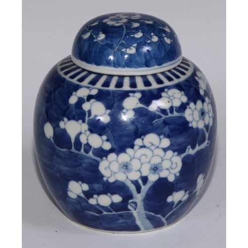 749 - A Chinese ovoid ginger jar and cover, painted in tones of underglaze blue with blossoming prunus on ... 