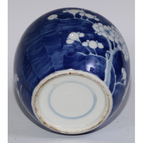 749 - A Chinese ovoid ginger jar and cover, painted in tones of underglaze blue with blossoming prunus on ... 