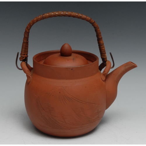 769 - A Japanese Yixing type terracotta kettle and stand, 30cm high overall