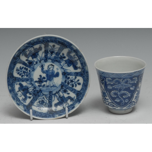 753 - A Chinese wine cup, painted in tonese of underglaze blue with flowers and scrolls within lotus reser... 