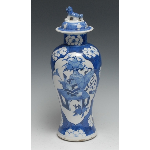 735 - A Chinese baluster vase and cover, painted in tones of underglaze blue with auspicious objects on a ... 