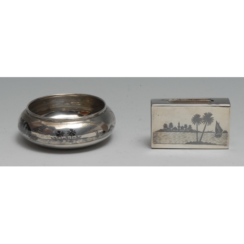 288 - An Iraqi silver and niello bowl or salt, typically decorated with desert scenes, 7cm diam; a matchbo... 