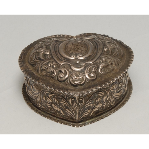 230 - A Victorian silver heart shaped dressing table box, embossed with leafy scrolls, the hinged cover ce... 