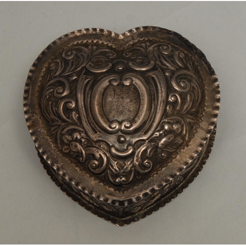 230 - A Victorian silver heart shaped dressing table box, embossed with leafy scrolls, the hinged cover ce... 