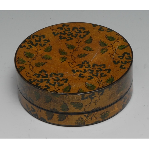 832 - A 19th century vernis martin papier mache circular snuff box, decorated overall with leafy stems on ... 