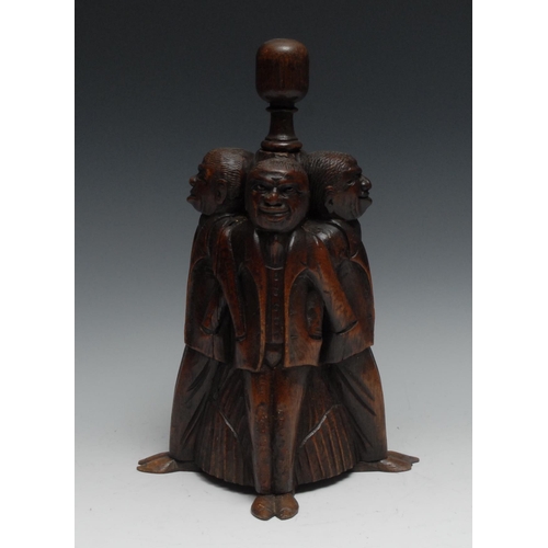 1067 - A 19th century oak door stop, amusingly carved as four figures, each with his hand in his fellow’s p... 