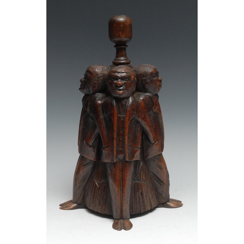 1067 - A 19th century oak door stop, amusingly carved as four figures, each with his hand in his fellow’s p... 