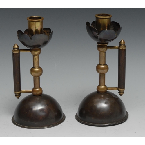 1186 - A pair of Arts & Crafts copper and brass candlesticks, attributed to Christopher Dresser for Benham ... 