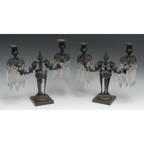 1196 - A pair of Regency dark patinated bronze two-light lustre candelabra, campana sconces, flowering corn... 