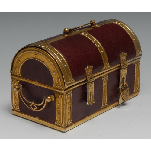 1153 - An early 20th century brass mounted red morocco leather sewing casket, as a domed trunk, the hinged ... 