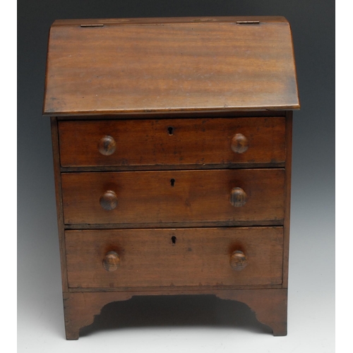 1068 - A 19th century Provincial mahogany miniature bureau, possibly Welsh, hinged front above three long g... 