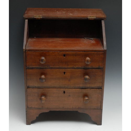 1068 - A 19th century Provincial mahogany miniature bureau, possibly Welsh, hinged front above three long g... 