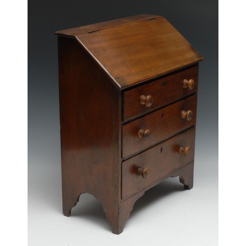 1068 - A 19th century Provincial mahogany miniature bureau, possibly Welsh, hinged front above three long g... 