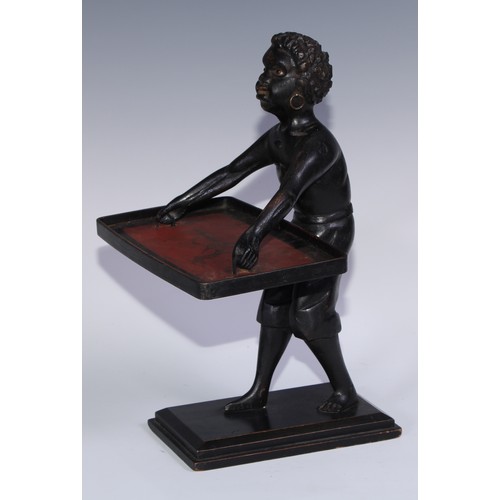 1247 - A Continental softwood table top blackamoor torchere, carved as a young boy holding a lacquer tray, ... 