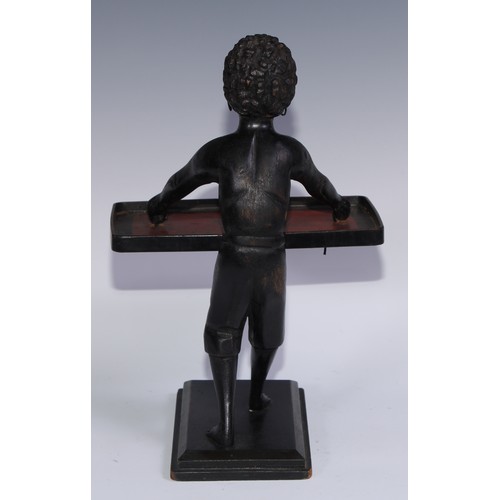 1247 - A Continental softwood table top blackamoor torchere, carved as a young boy holding a lacquer tray, ... 