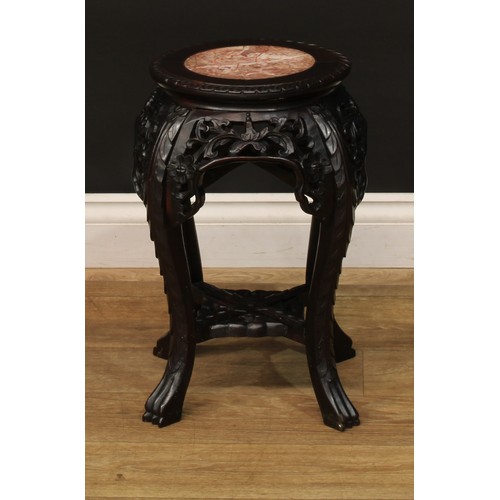 1028 - A Chinese hardwood jardiniere stand, circular top with inset marble panel, pierced and carved with l... 