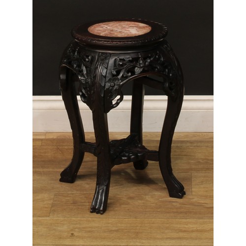 1028 - A Chinese hardwood jardiniere stand, circular top with inset marble panel, pierced and carved with l... 