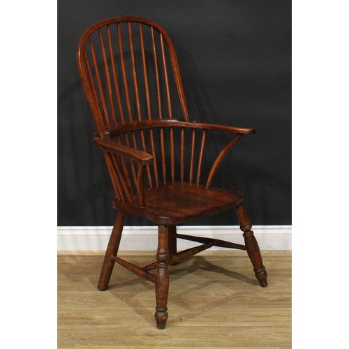 887 - A 19th century ash and elm stick back Windsor elbow chair, hoop back, outswept arms, saddle seat, tu... 