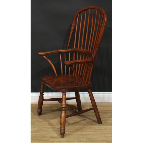 887 - A 19th century ash and elm stick back Windsor elbow chair, hoop back, outswept arms, saddle seat, tu... 