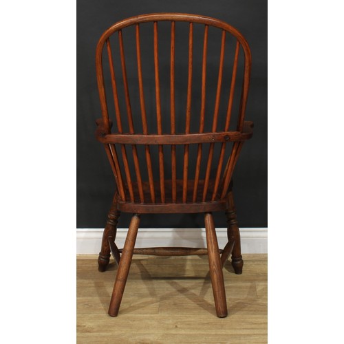 887 - A 19th century ash and elm stick back Windsor elbow chair, hoop back, outswept arms, saddle seat, tu... 