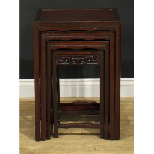 1116 - A set of Chinese hardwood quartetto tables, rectangular panel tops, each frieze pierced and carved w... 