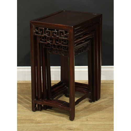 1116 - A set of Chinese hardwood quartetto tables, rectangular panel tops, each frieze pierced and carved w... 