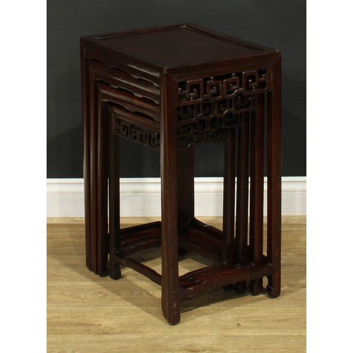 1116 - A set of Chinese hardwood quartetto tables, rectangular panel tops, each frieze pierced and carved w... 