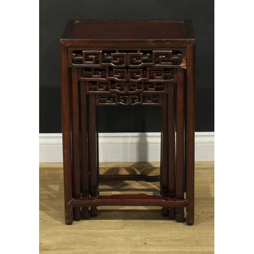 1116 - A set of Chinese hardwood quartetto tables, rectangular panel tops, each frieze pierced and carved w... 