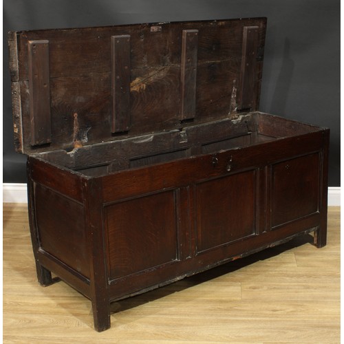 1015 - A Charles II oak blanket chest, hinged top above a three panel front, stile feet, 65cm high, 142cm w... 