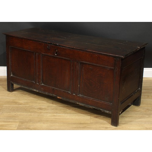 1015 - A Charles II oak blanket chest, hinged top above a three panel front, stile feet, 65cm high, 142cm w... 