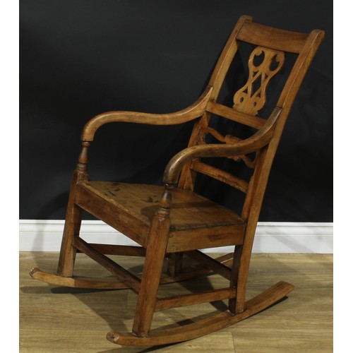 902 - A 19th century fruitwood rocking chair, shaped and pierced splat, downswept arms, 91cm high, 57cm wi... 