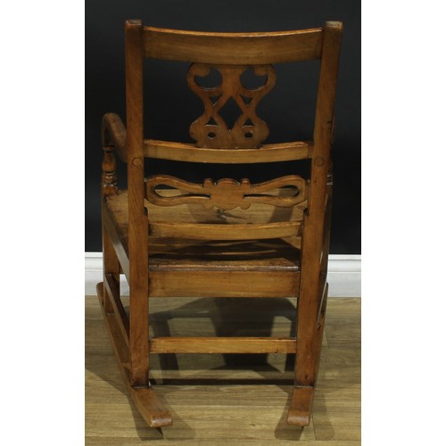 902 - A 19th century fruitwood rocking chair, shaped and pierced splat, downswept arms, 91cm high, 57cm wi... 