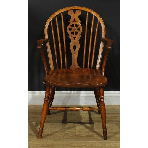 897 - A 19th century elm wheelback Windsor elbow chair, hoop back, shaped and pierced splat, saddle seat, ... 