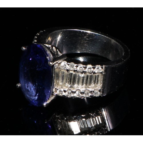 368 - An 18ct white gold diamond and tanzanite ring, 5.83ct central oval tanzanite, flanked by ten baguett... 