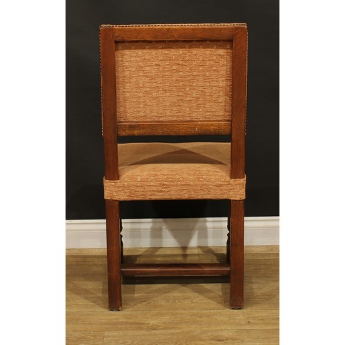 1130 - A set of twelve late Victorian Cromwellian Revival oak dining chairs, by Howard & Sons, comprising t... 