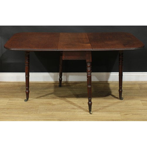 1431 - A Regency mahogany gateleg table, rounded rectangular top with channelled edge and fall leaves, ring... 