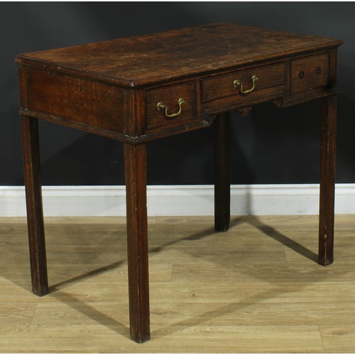 1165 - A George III oak lowboy or side table, rectangular top above three frieze drawers, moulded internall... 