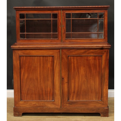 922 - A 19th century mahogany dining room press cabinet, rectangular superstructure with two doors, the pr... 