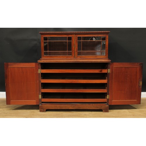 922 - A 19th century mahogany dining room press cabinet, rectangular superstructure with two doors, the pr... 