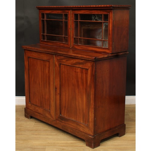 922 - A 19th century mahogany dining room press cabinet, rectangular superstructure with two doors, the pr... 