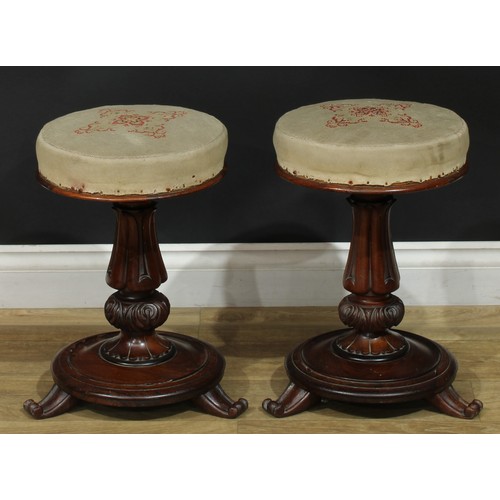 1412 - A pair of William IV rosewood height-adjustable piano stools, each with stuffed-over seat, lotus col... 