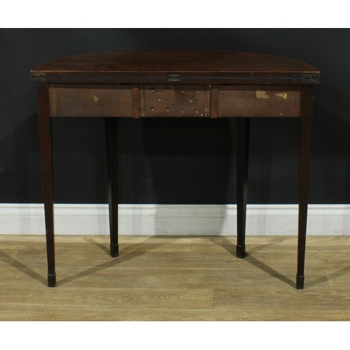 1114 - A George III mahogany demilune card table, hinged crossbanded top enclosing a baize lined playing su... 