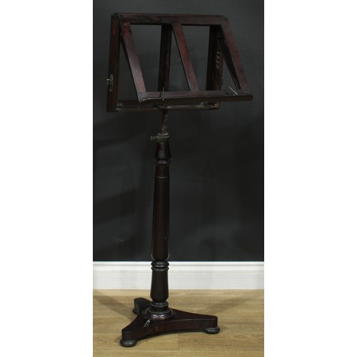 930 - A 19th century mahogany music stand, turned column, incurve triform base, bun feet, 113cm raising to... 