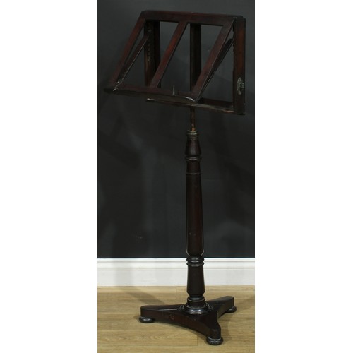 930 - A 19th century mahogany music stand, turned column, incurve triform base, bun feet, 113cm raising to... 