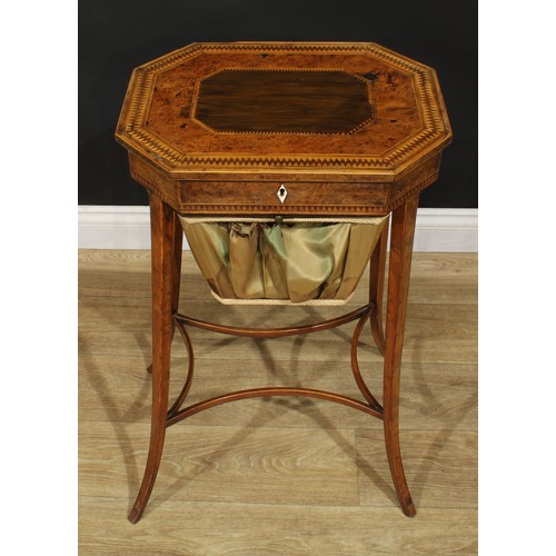 891 - A 19th century burr yew and parquetry work table, hinged top with dogtooth border above a basket und... 