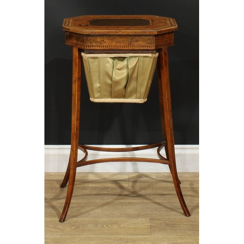 891 - A 19th century burr yew and parquetry work table, hinged top with dogtooth border above a basket und... 